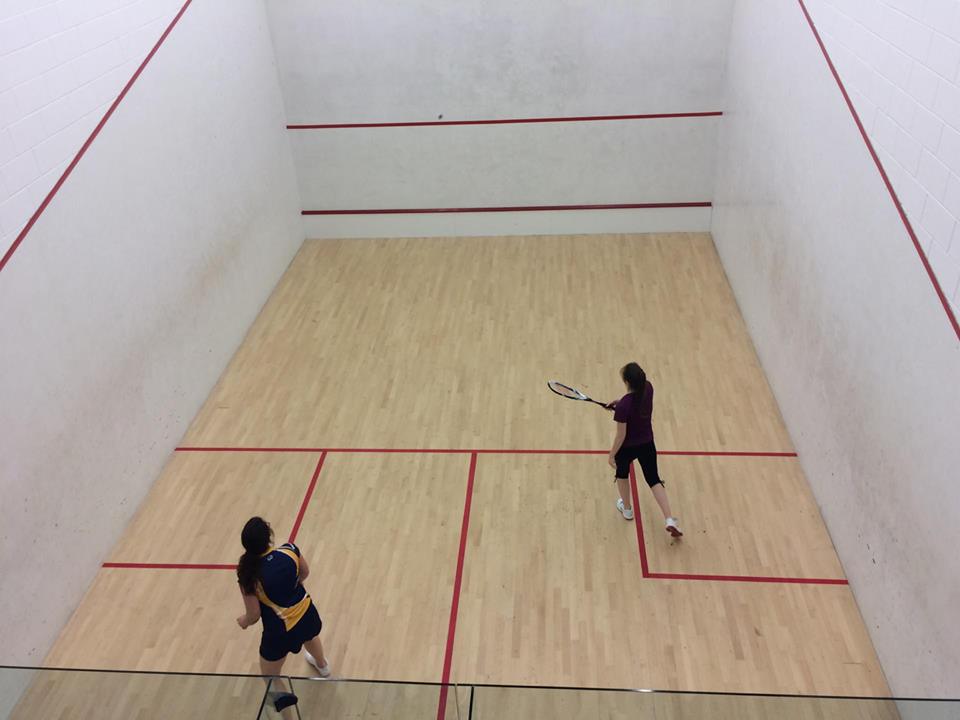 University of Lincoln's women's team cmpetitor againt one of the members of the Anglia Ruskin Squash team